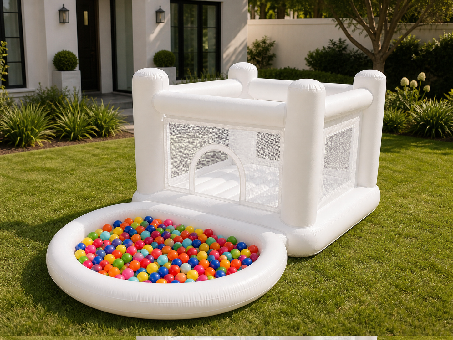 White Bouncy Castle and included multicolor ball pit in a manicured backyard